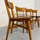 Set of 4 vintage solid oak chairs, 1960s design with sculpted backrest.