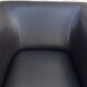 2 club armchairs with a chocolate faux leather seat and backrest and wooden legs.