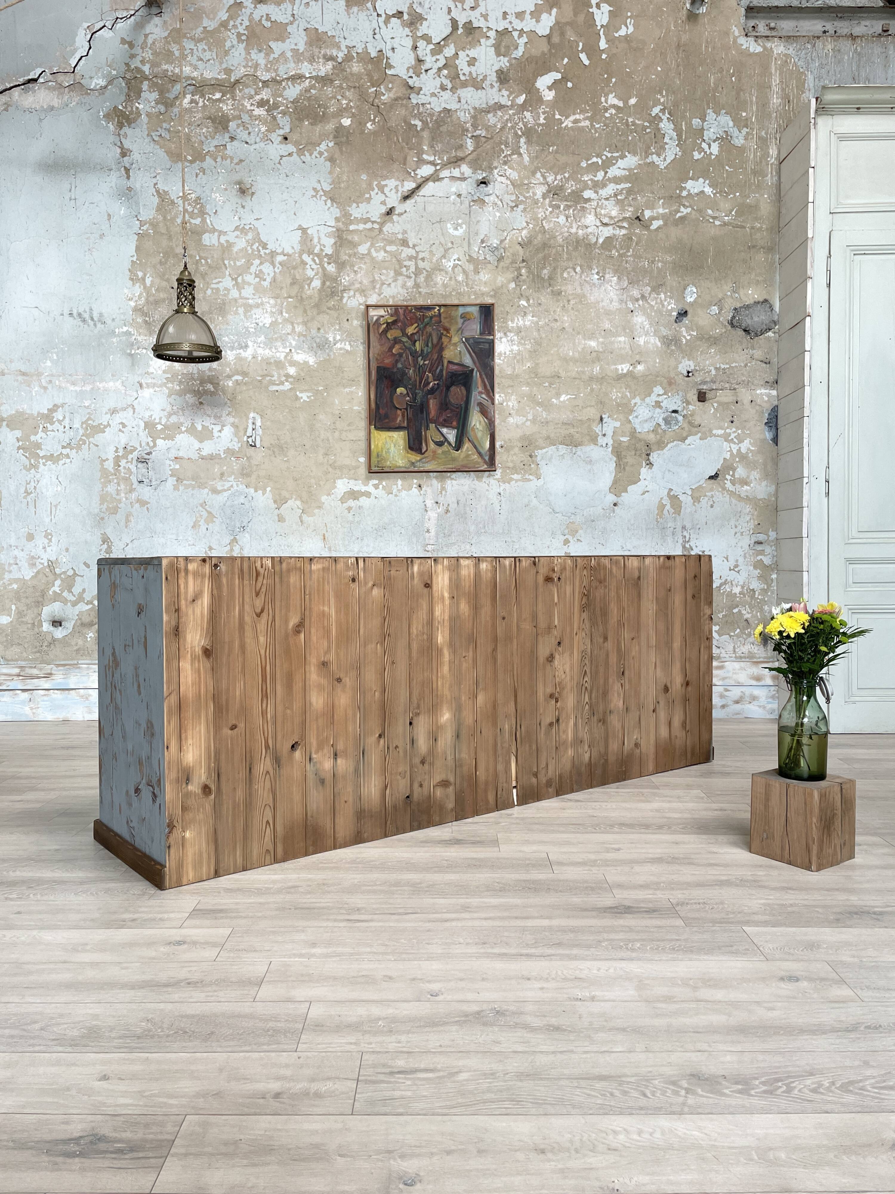 Artisanal workshop bank in patinated wood, circa 1950.