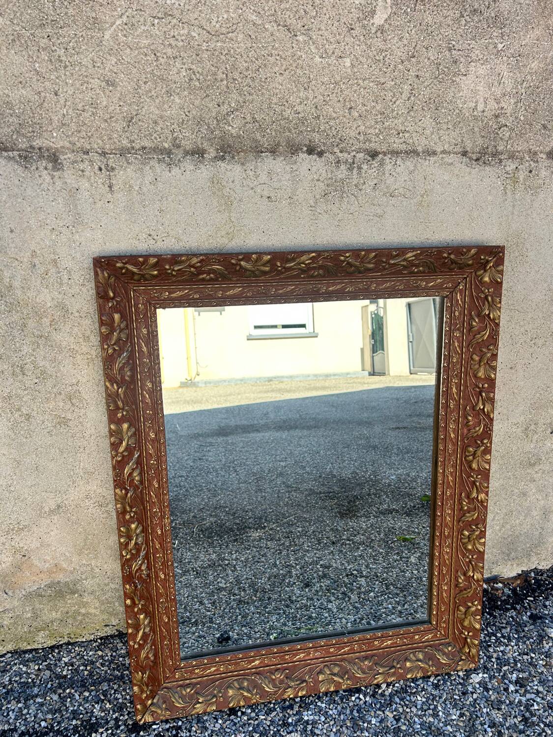 Antique mirror in patinated gilt wood