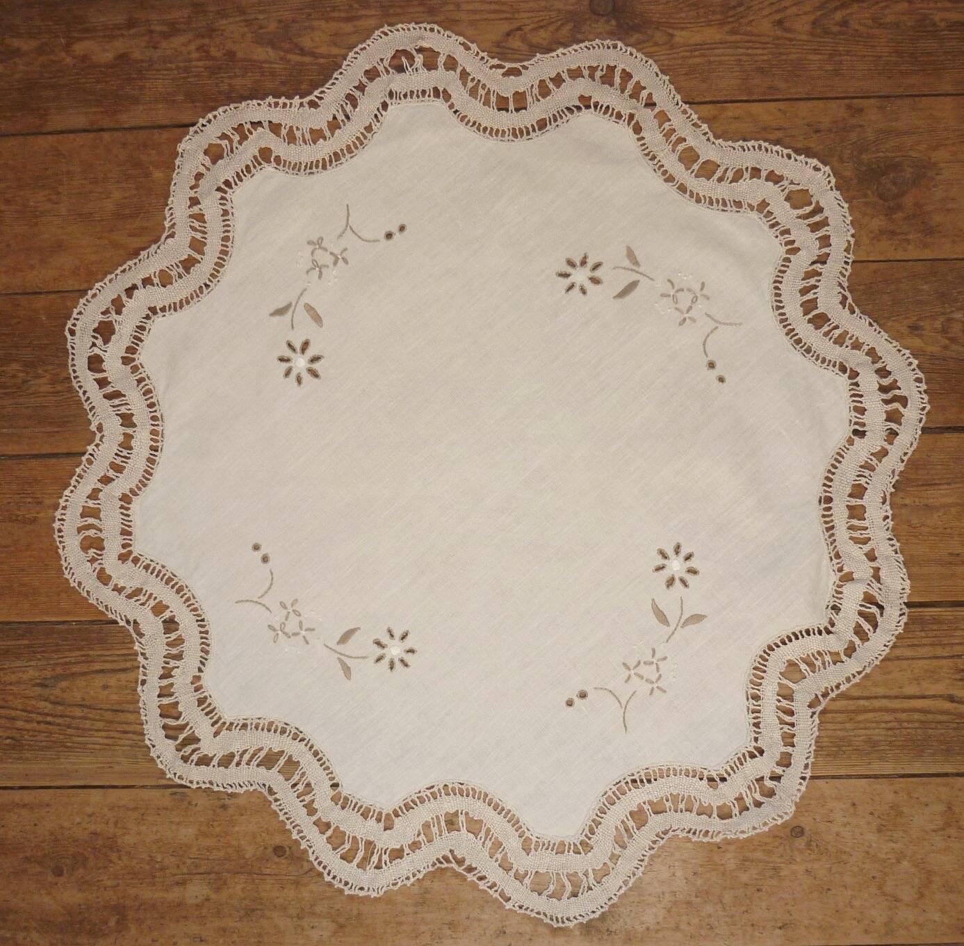 Round embroidered and crocheted doily