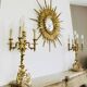 Massive gilded bronze chandeliers from the mid-20th century with marble bases.