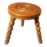 Wooden milking stool with twisted legs