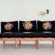 Old bench upholstered in black canvas flowers