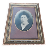 Old photo portrait framed in wood and stucco