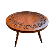 Circular tripod coffee table in carved wood
