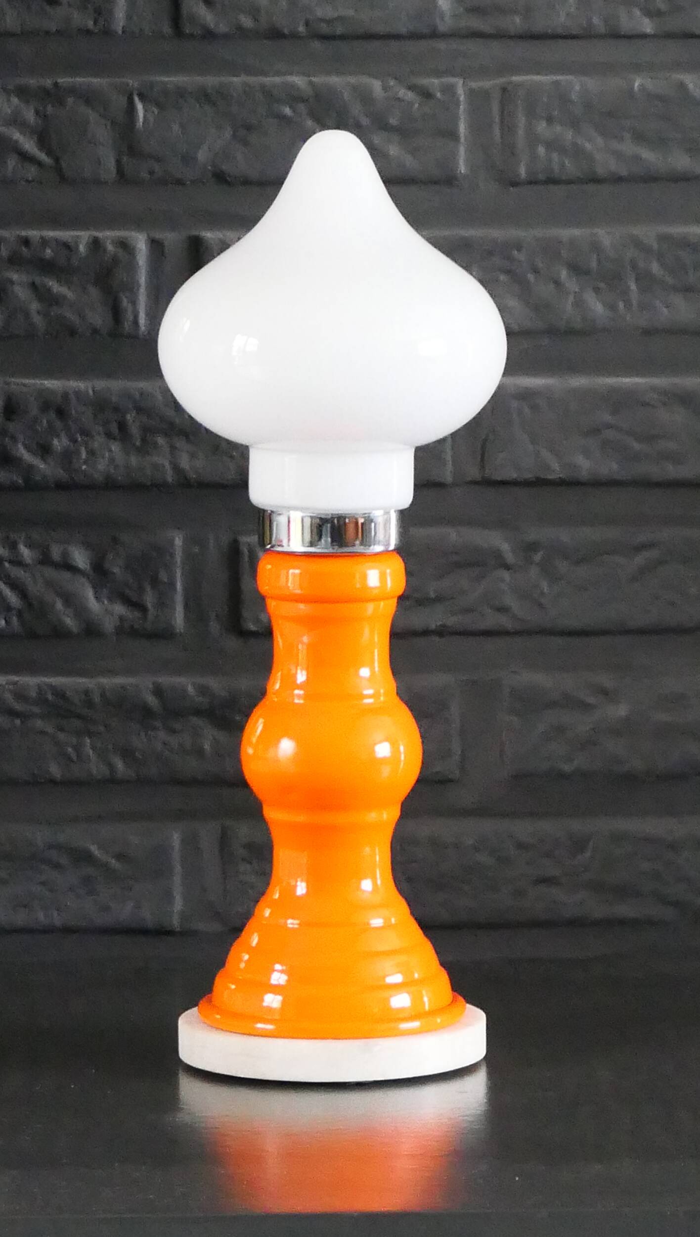 Table lamp or bedside lamp from the 1960s-70s in orange and chrome.