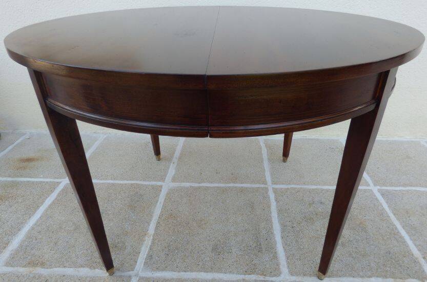 Round mahogany table with mahogany veneer and brass sabot foot.