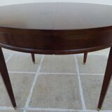 Round mahogany table with mahogany veneer and brass sabot foot.