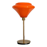 Table lamp with a vintage orange glass globe and a gold base