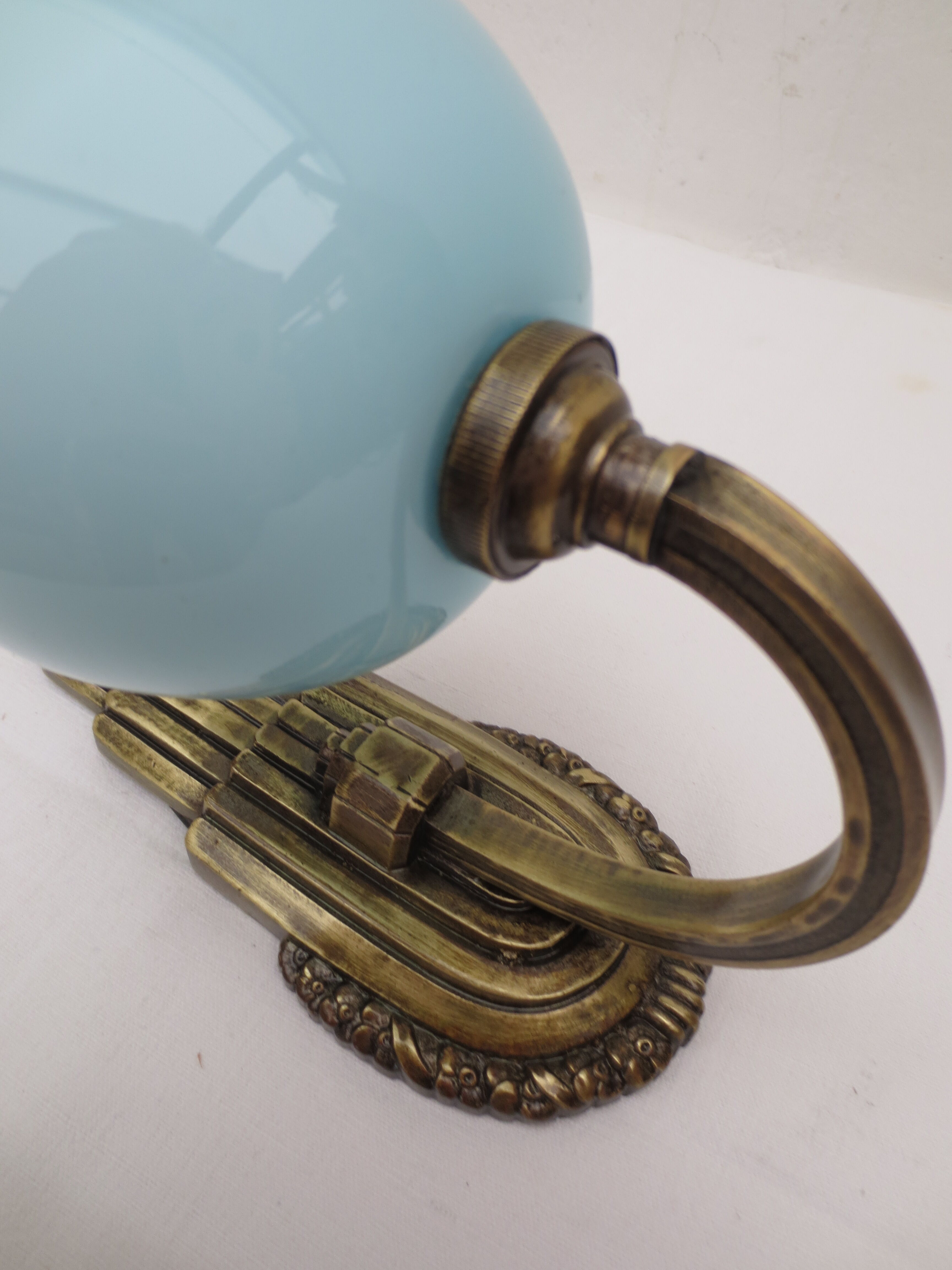 Art deco wall lamp in brass and soft blue opaline globe