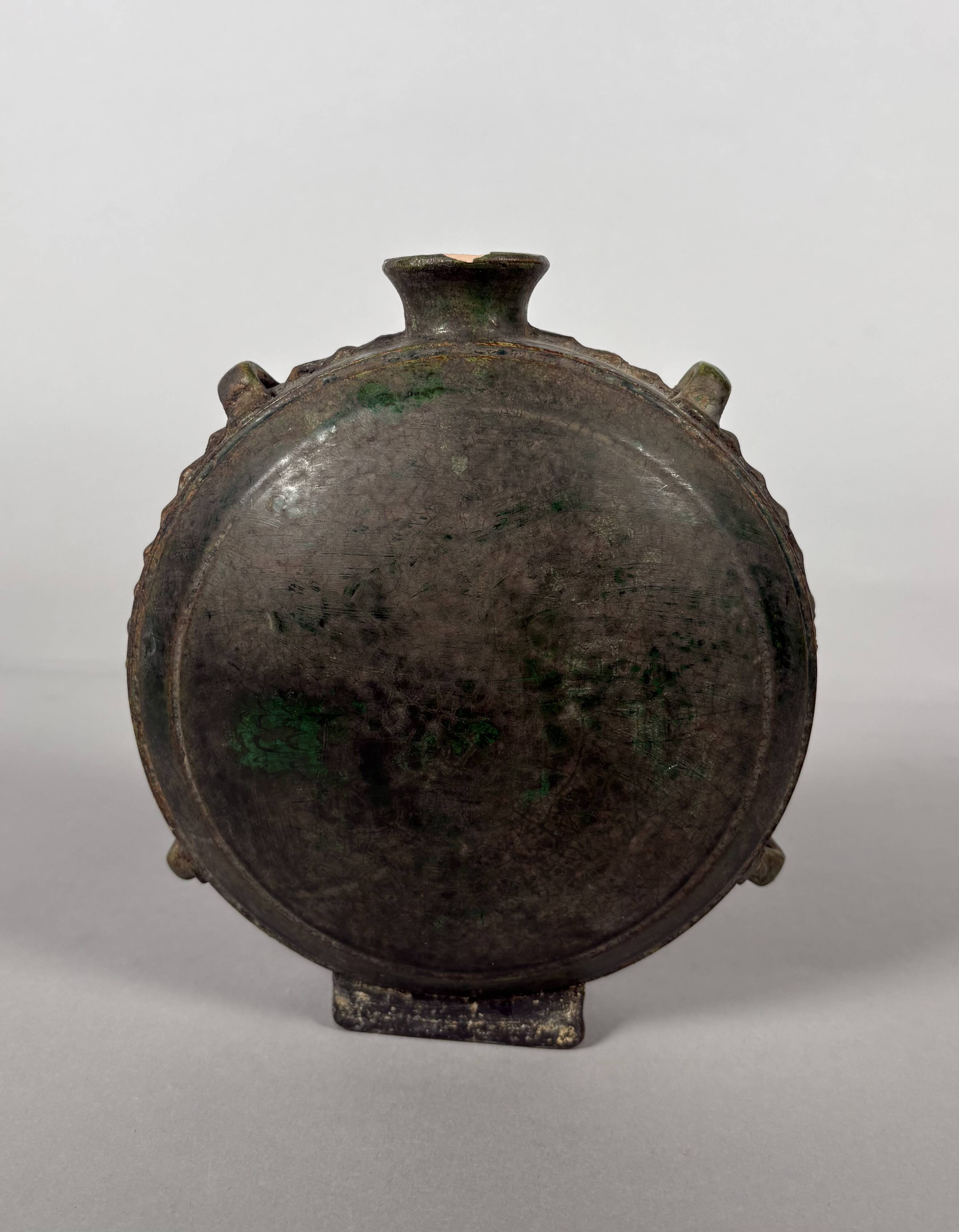 Nomadic rider's jug in green glazed earthenware, China, Tang Dynasty.