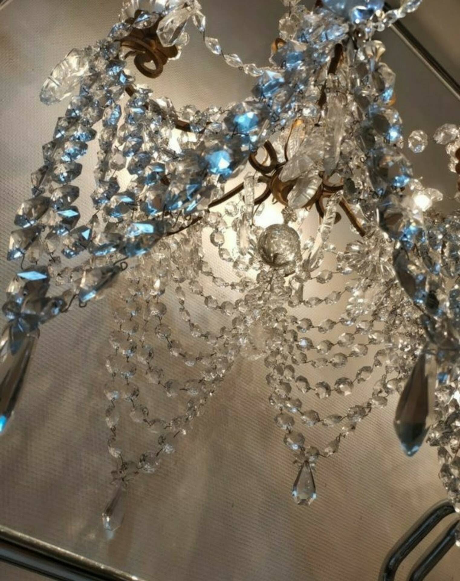A pair of imposing, antique chandeliers with pendants.