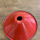 Suspension in red enamelled sheet metal