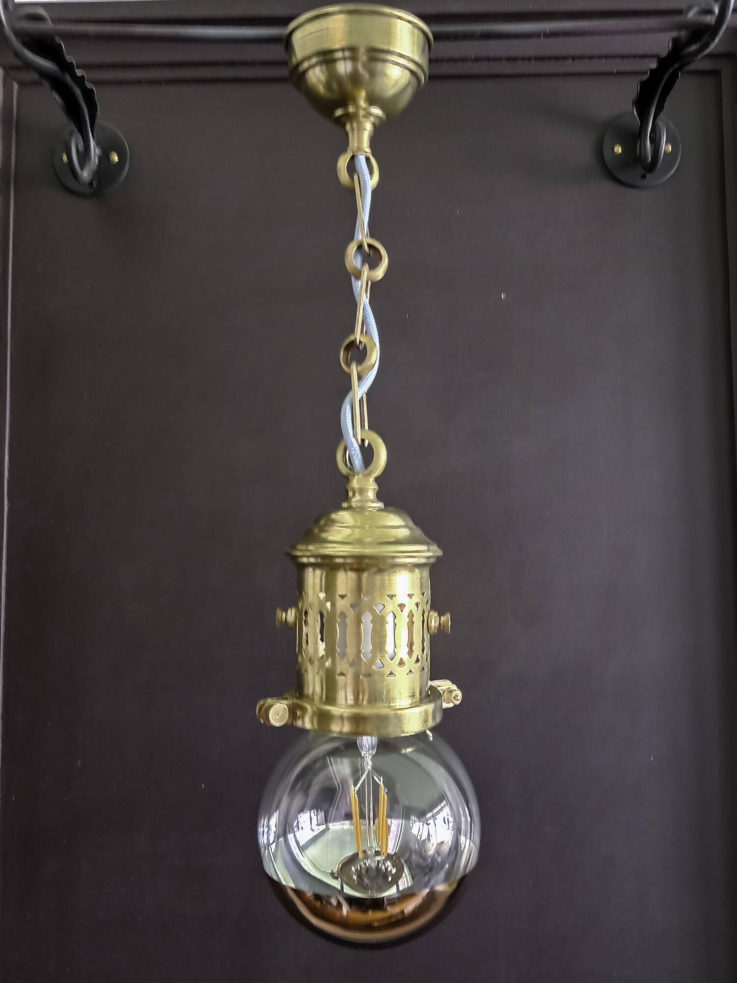 Brass pendant light with oversized LED bulb
