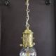 Brass pendant light with oversized LED bulb