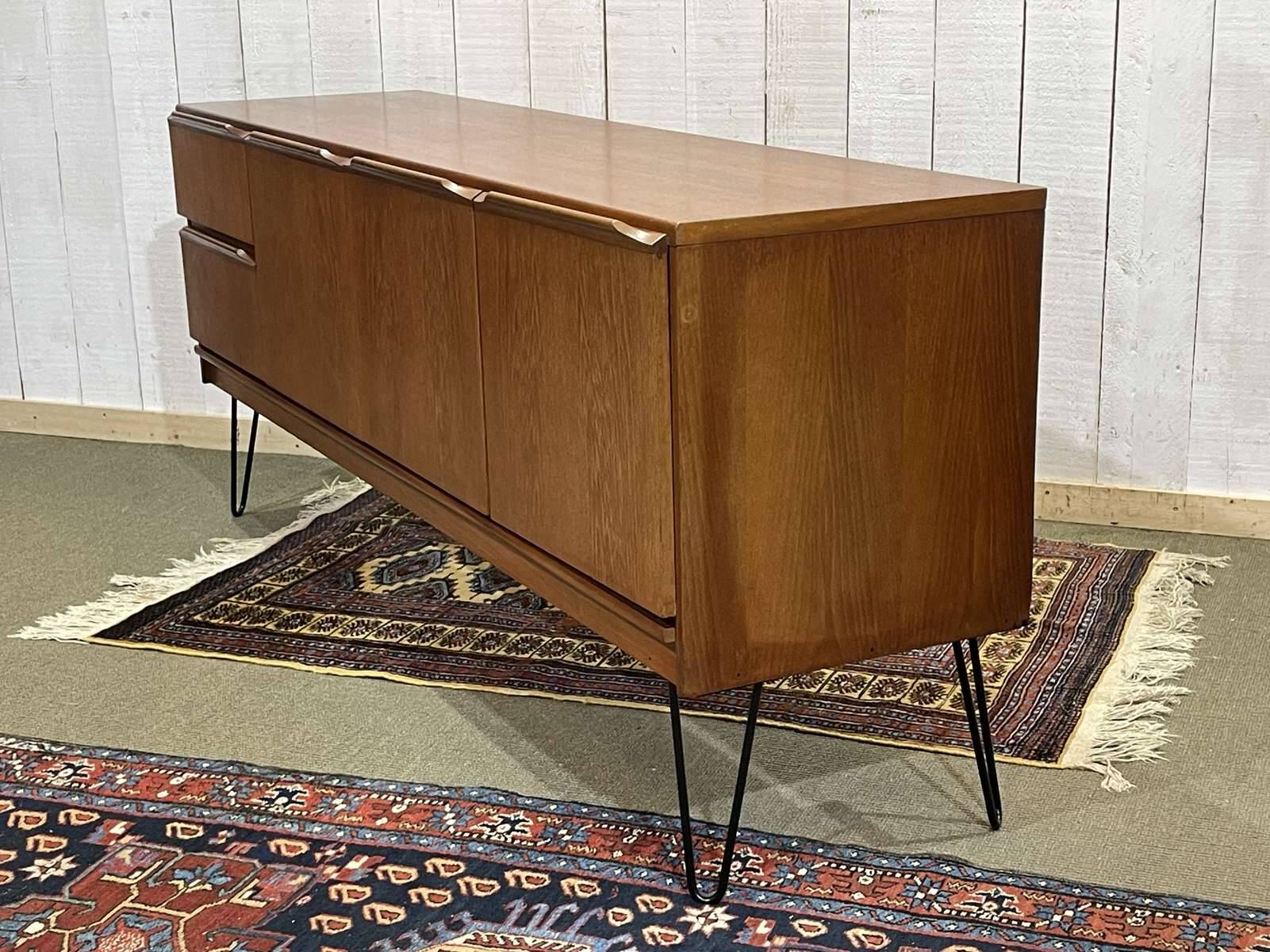 1970s English enfilade in teak with splayed legs.