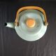 Teapot in enamelled tole green almond