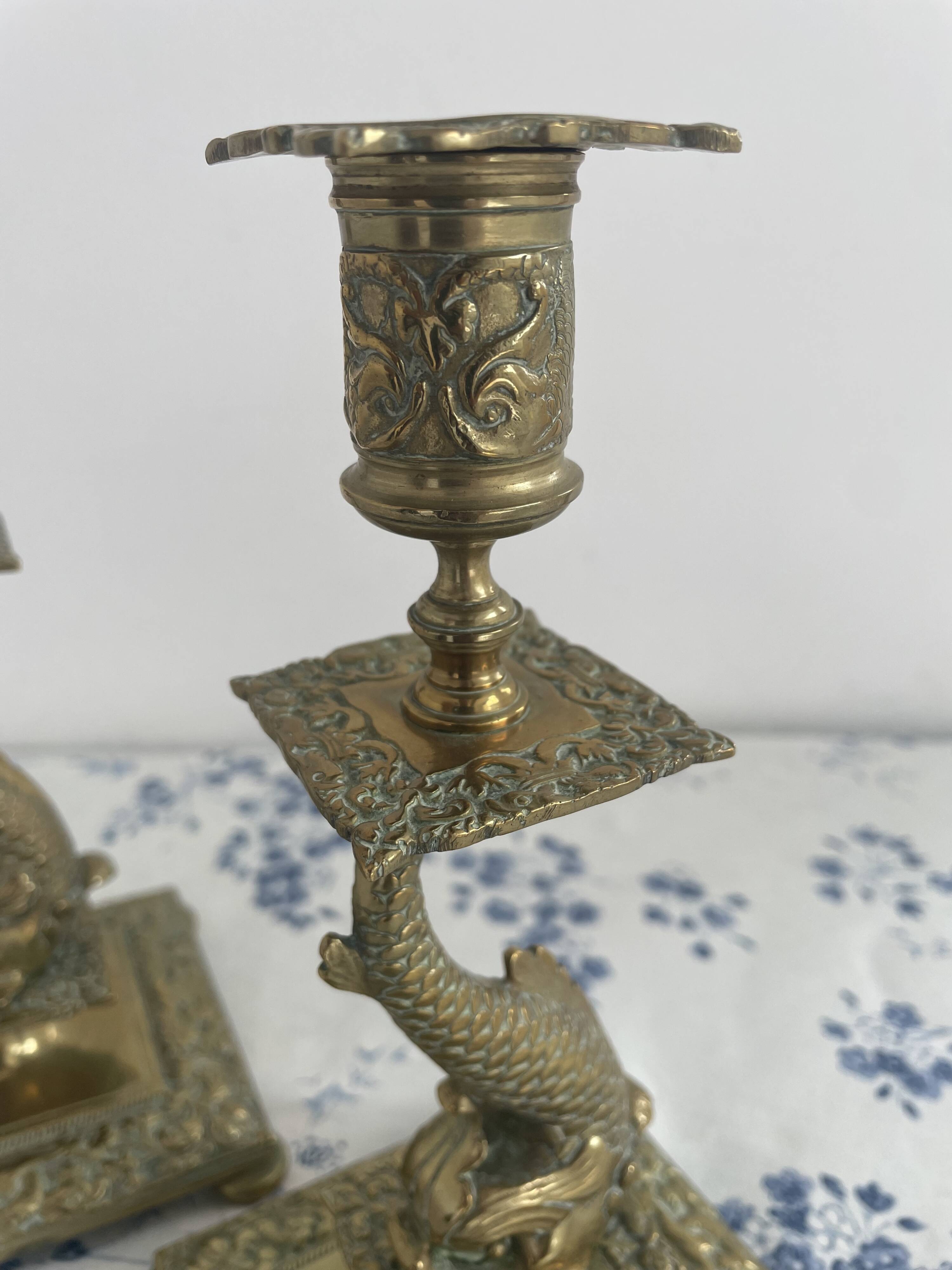 Pair of brass dolphin candlesticks, late 19th century, Napoleonic period