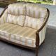 Two-seater Louis XVI canapé in golden beige fabric and curved solid wood.