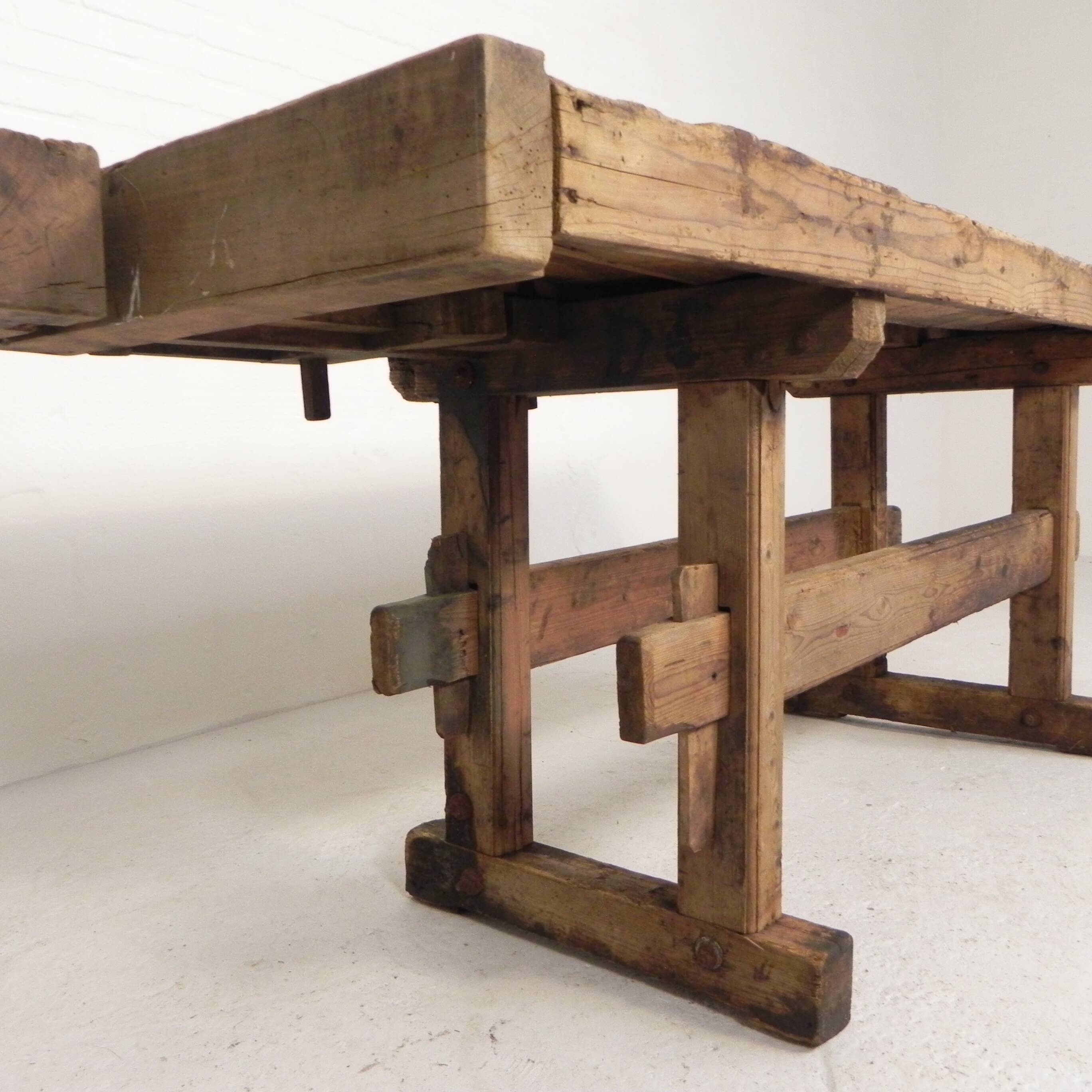 Wooden industrial workbench with vice, 194 cm long, 1930s.