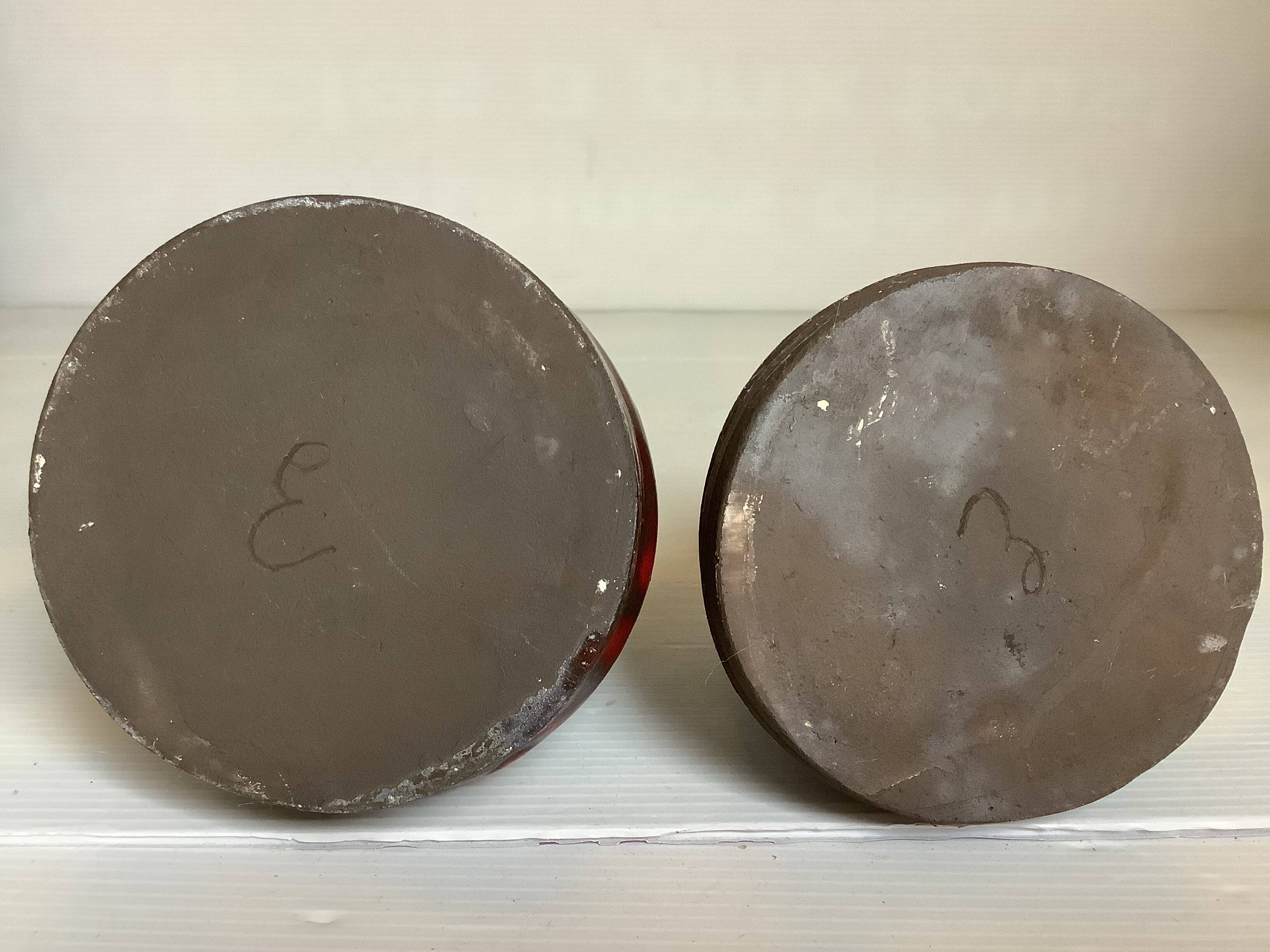 Pair of red vases in the shape of an elephant's foot