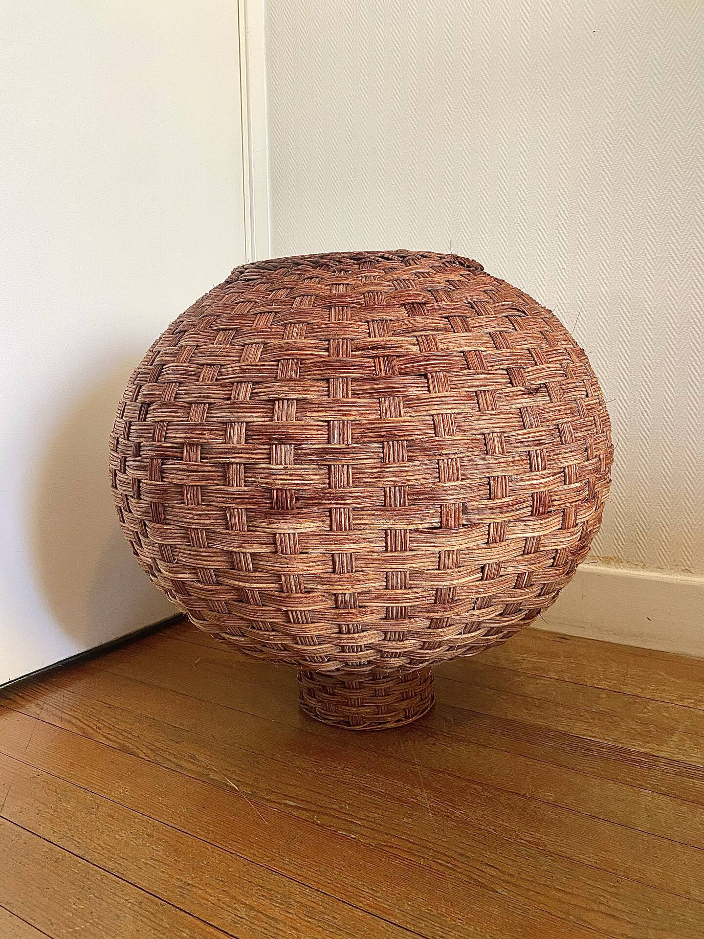 Large vintage lampshade made of hand-woven rattan.