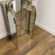Vintage triptych mirror in brass with wall lights.