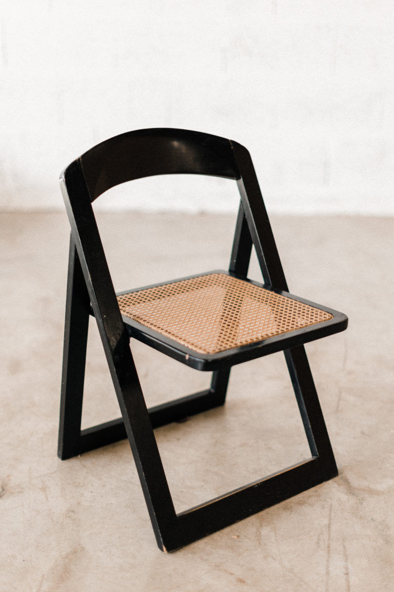 Folding black cannage chair