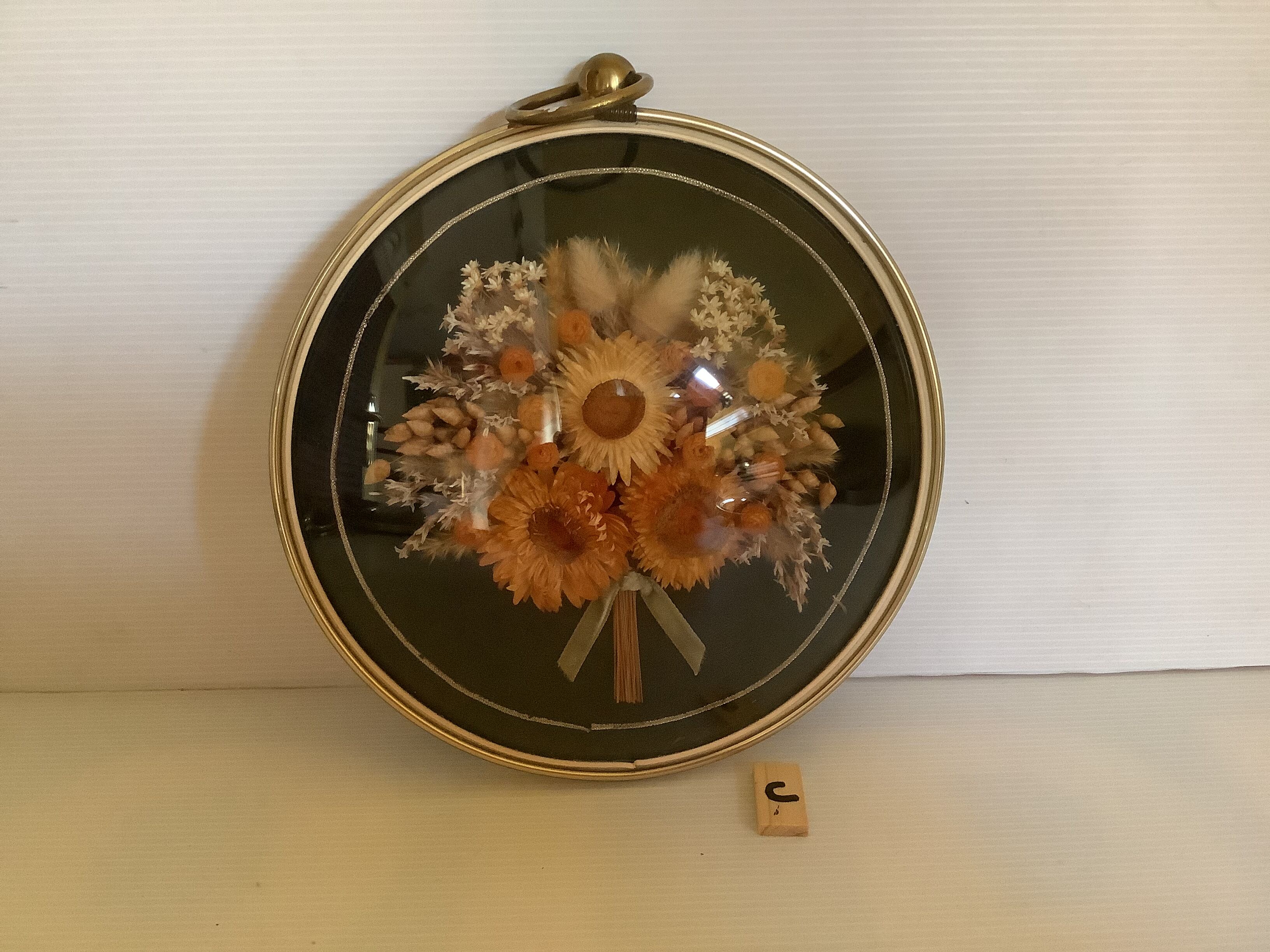 Old round frame curved glass dried flowers immortelle