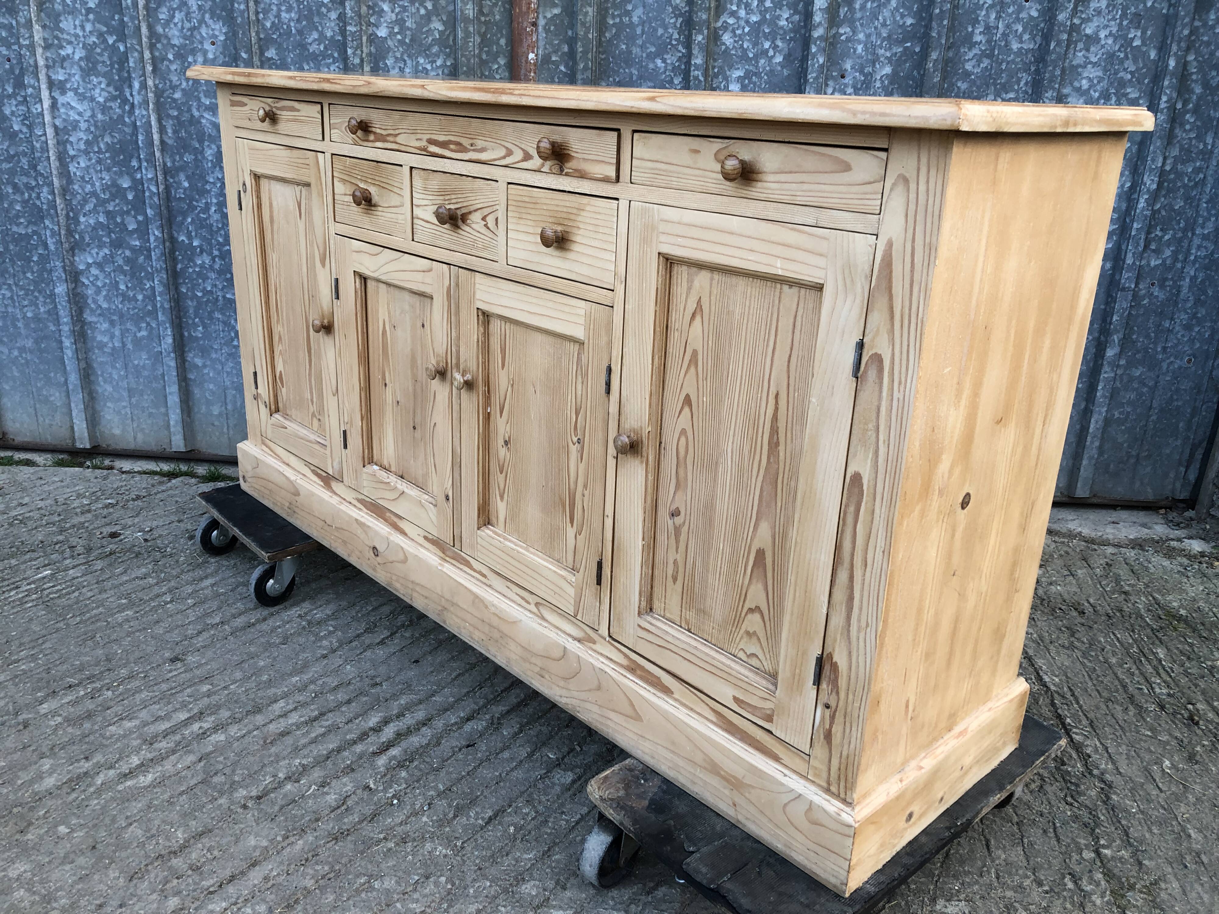 Scandinavian natural pine sideboard with 4 doors and 6 drawers.