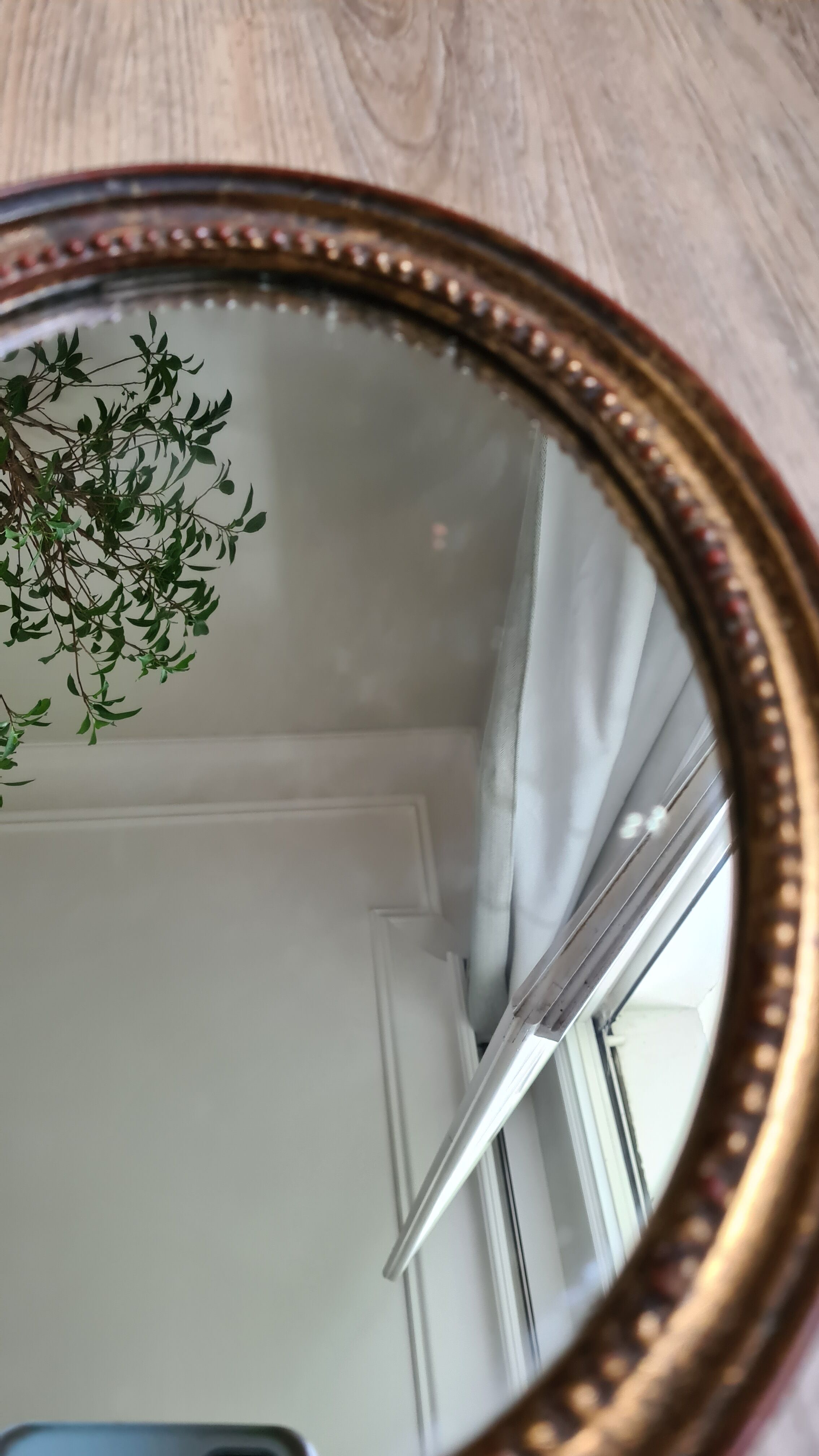 Old oval mirror in gilded wood