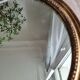 Old oval mirror in gilded wood