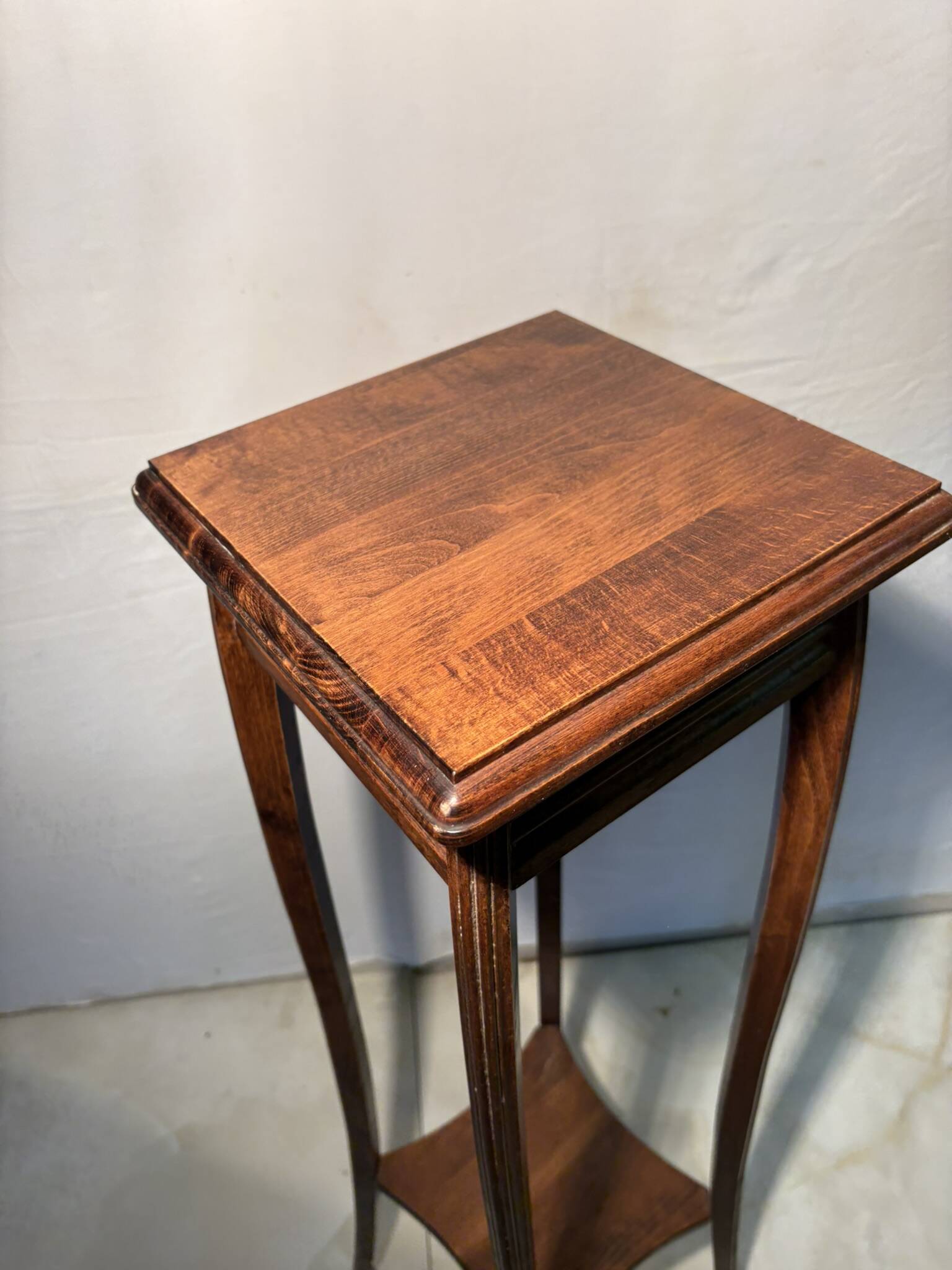 Vintage dark wood side table with curved base