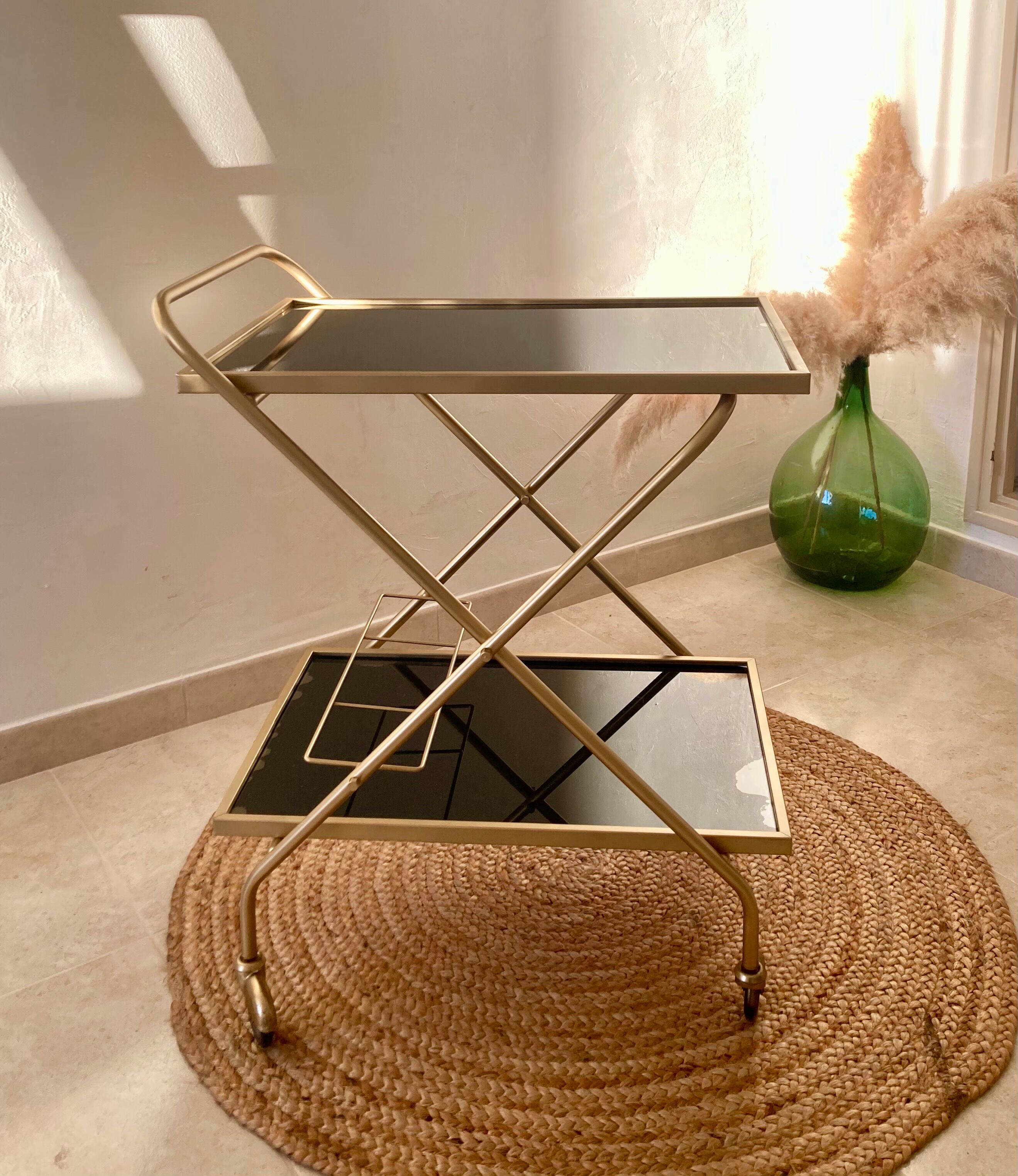 Golden dessert on wheels with black glass trays