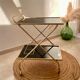 Golden dessert on wheels with black glass trays