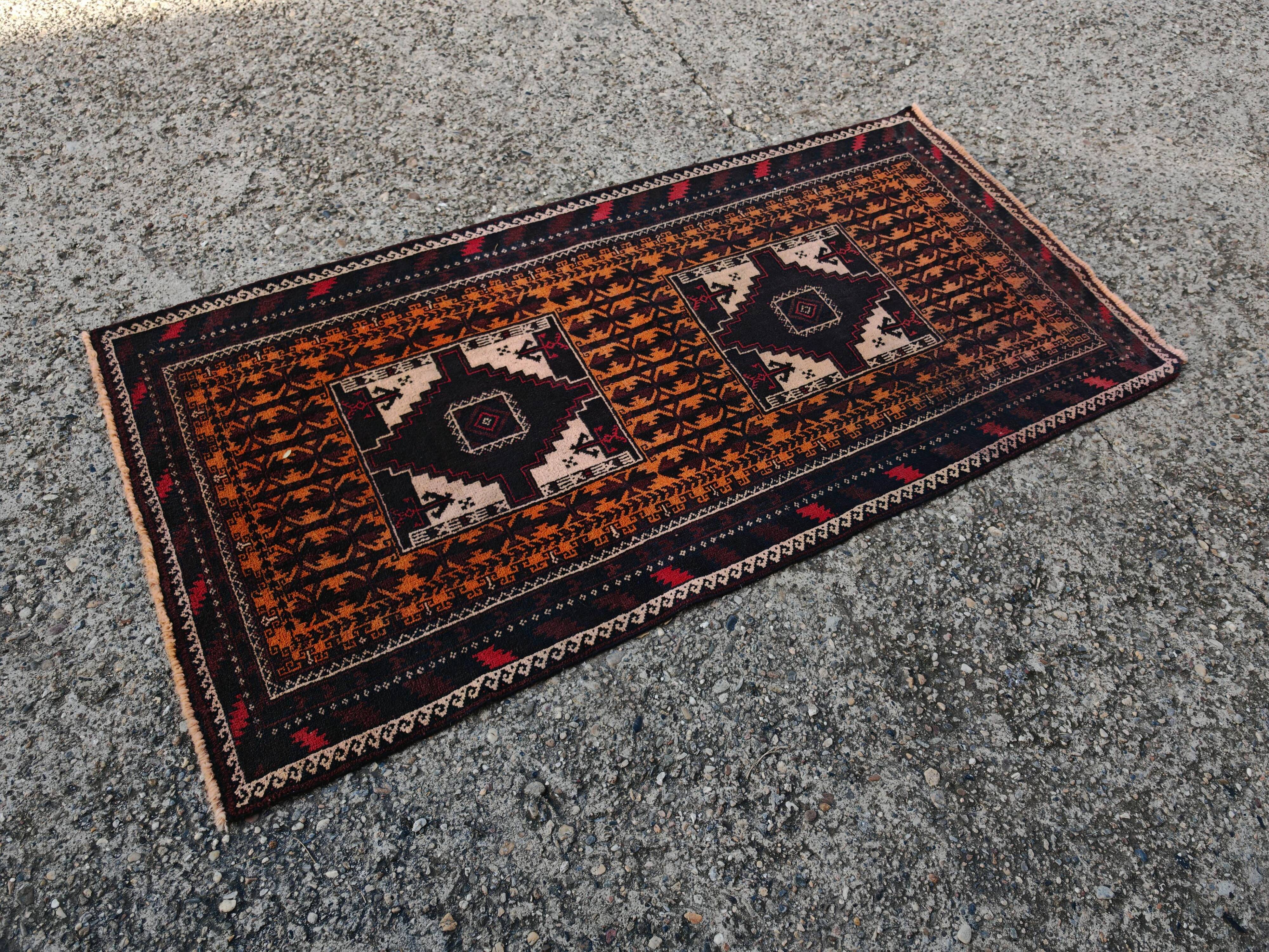 Vintage Persian Baluch rug, hand-knotted wool, 1970.