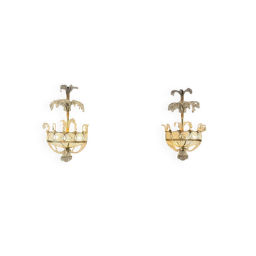Pair of painted and gilded metal wall sconces adorned with crystals, Italy circa 1920.