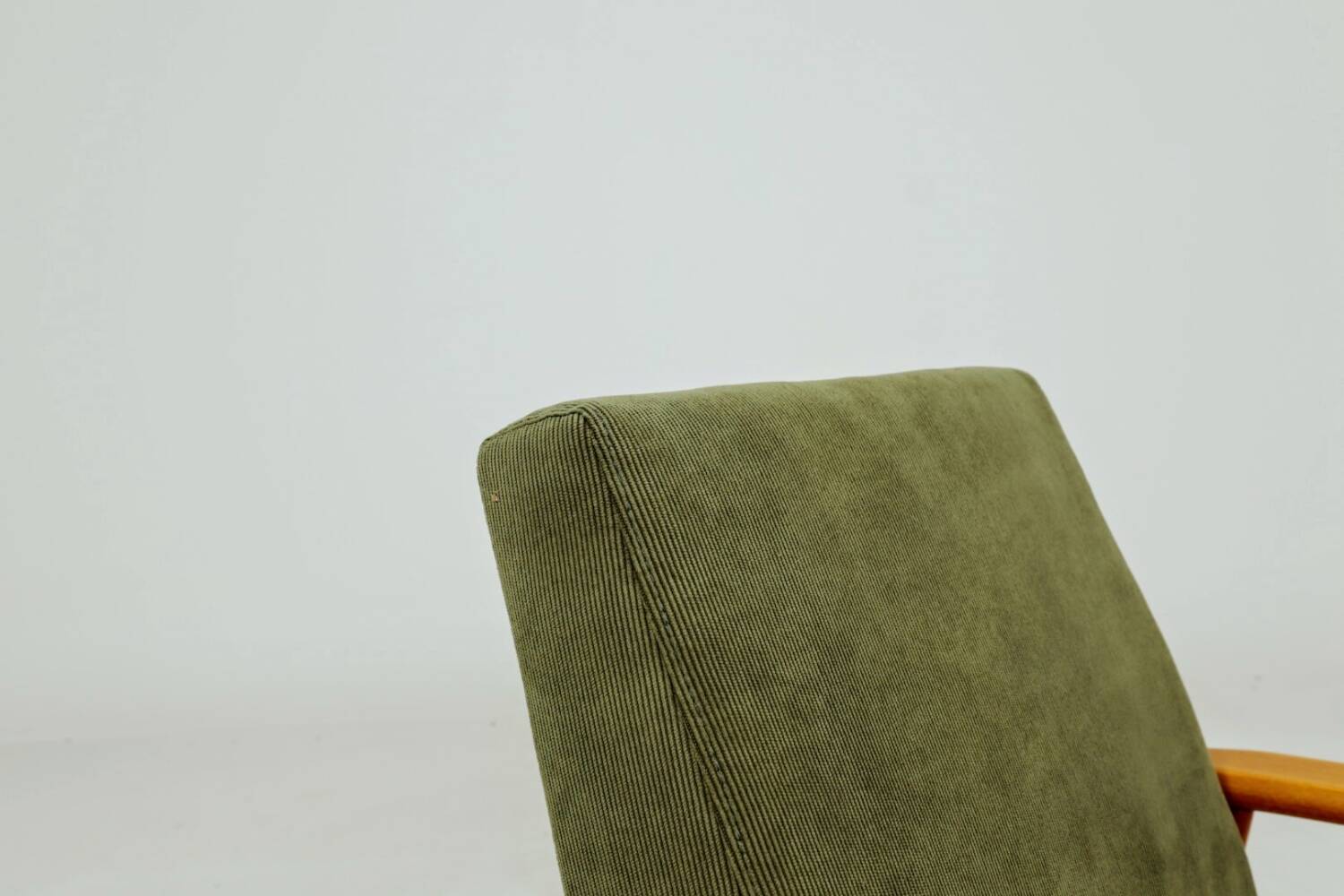 Mid-century modern design armchair in olive green corduroy.