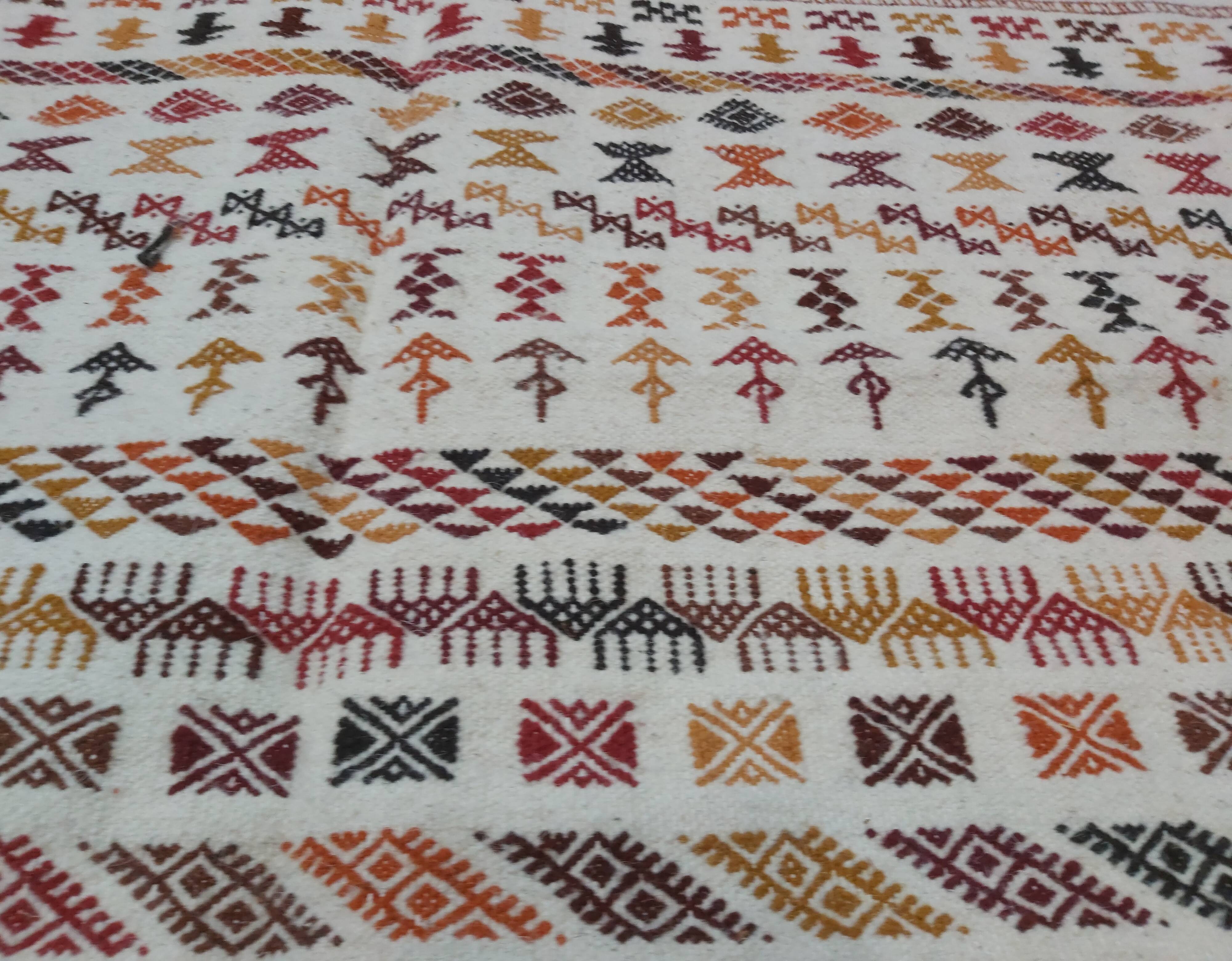 White carpet with multicolored Berber patterns
