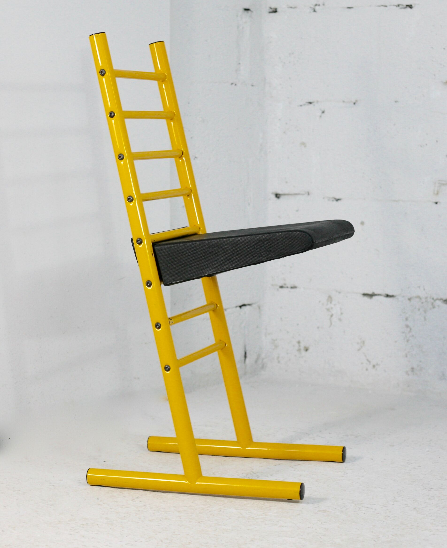 Adjustable seat chair. Circa 1980. Italy. Yellow lacquered steel.
