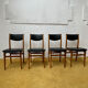 4 Scandinavian chairs in teak and black faux leather.