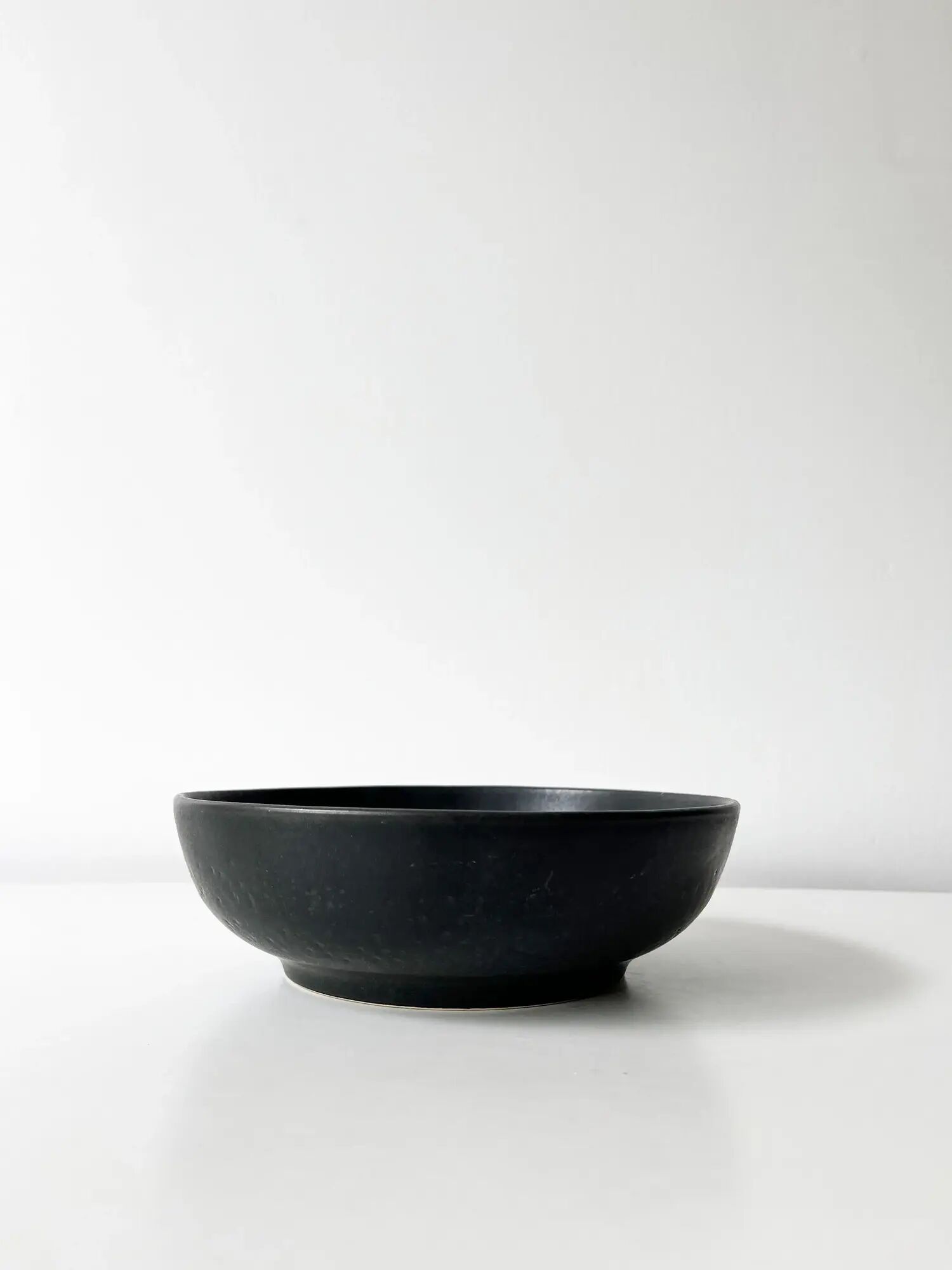 Round vintage black ceramic catchall.