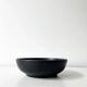 Round vintage black ceramic catchall.