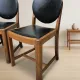 Set of four vintage wooden dining chairs with black leather upholstery, 85 × 45 × 45 cm
