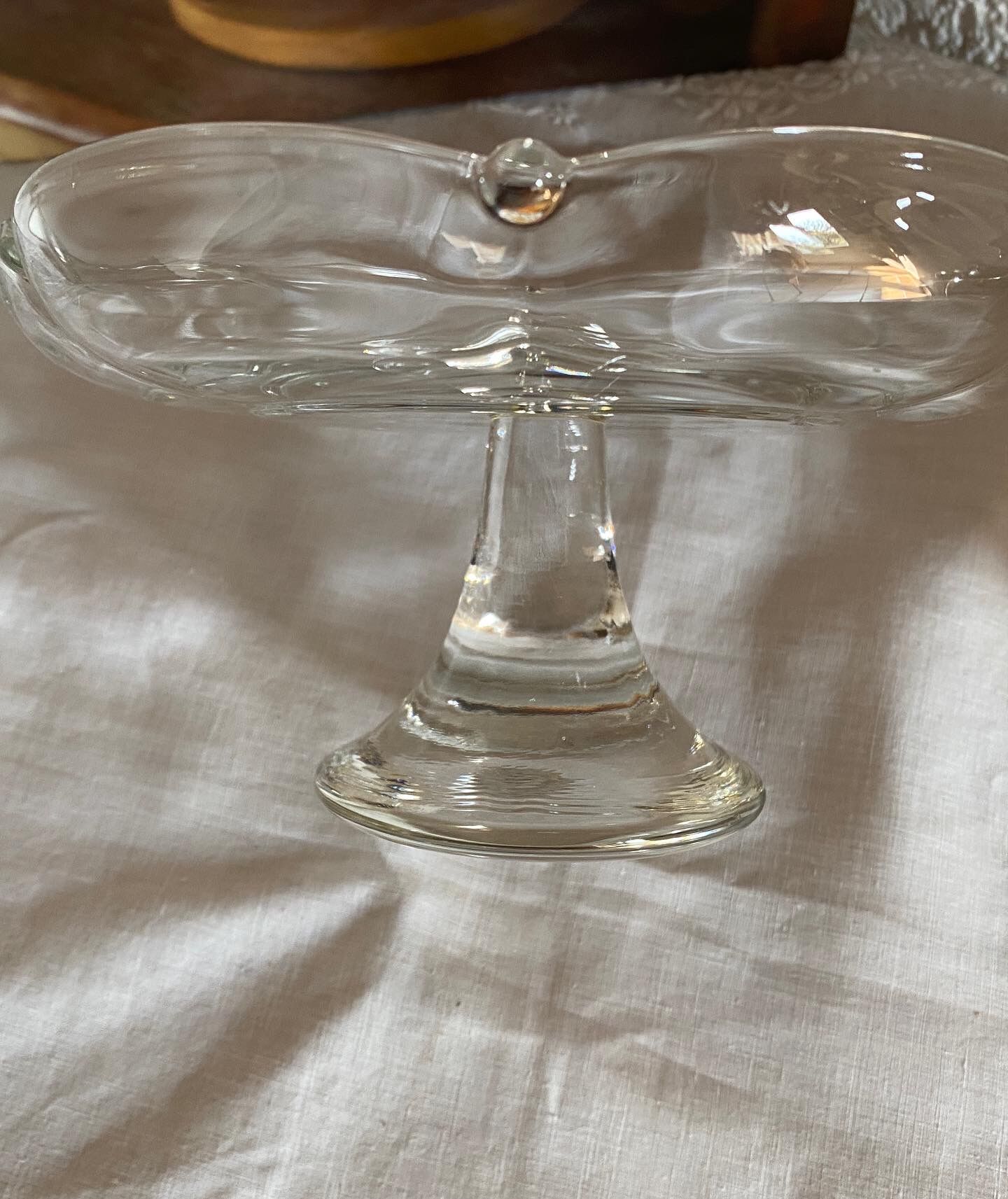 Standing molded glass cup depicting a flower