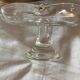 Standing molded glass cup depicting a flower
