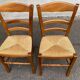 2 wooden dining chairs with rush seats from the 1970s.