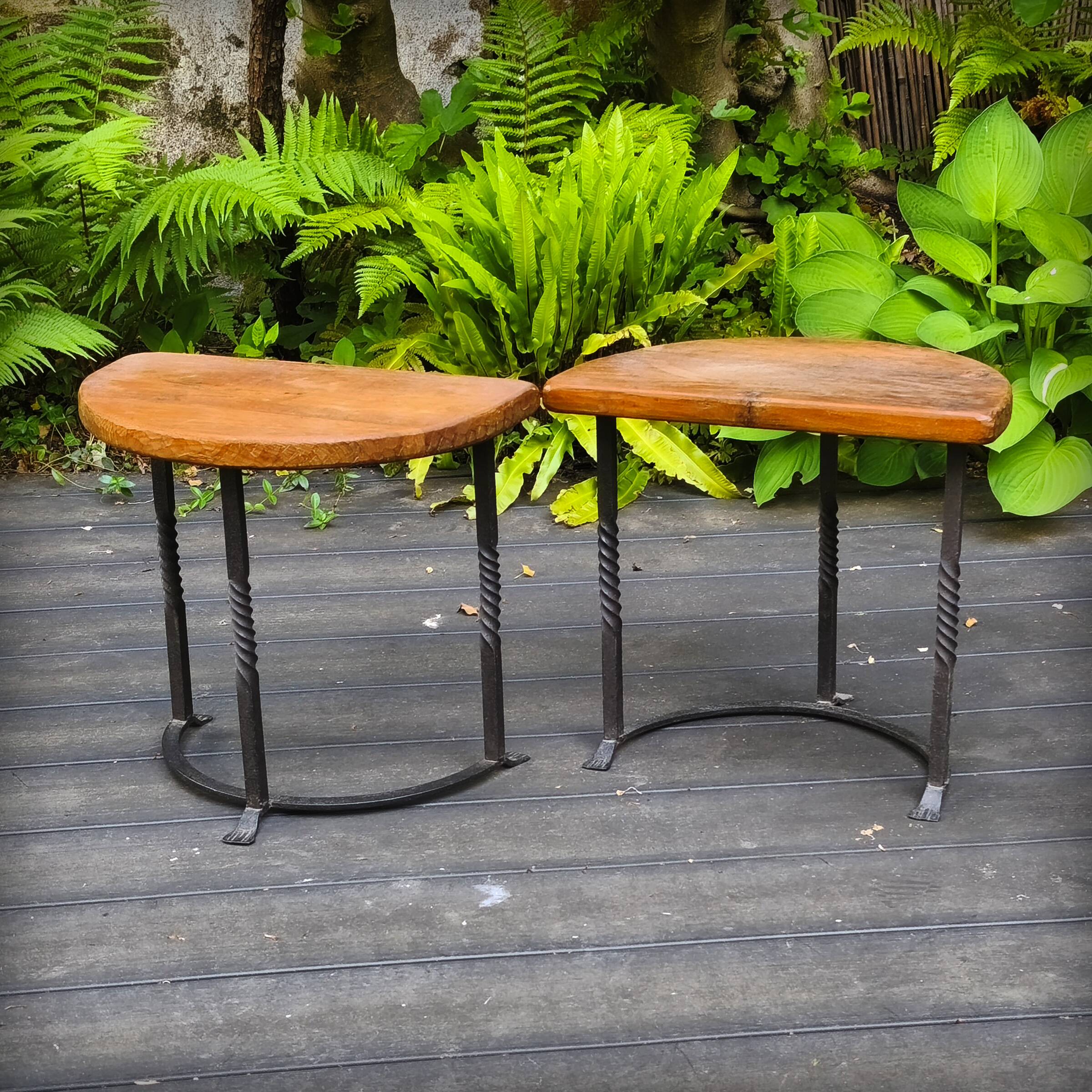 Pair of wrought iron and oak side tables, France, 1930.