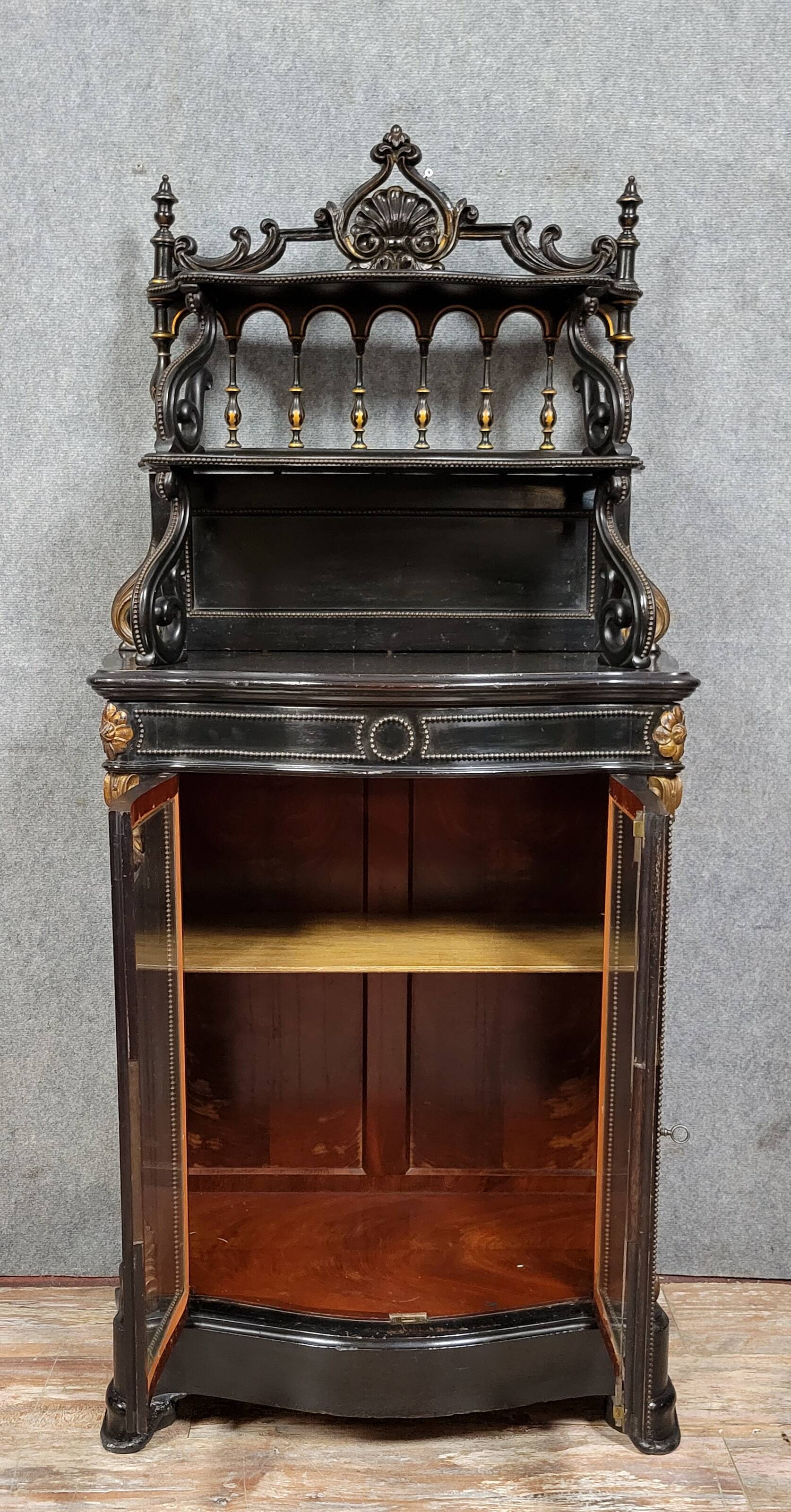 Curved "Boulle" display case from the Napoleon III period in blackened and gilded wood
